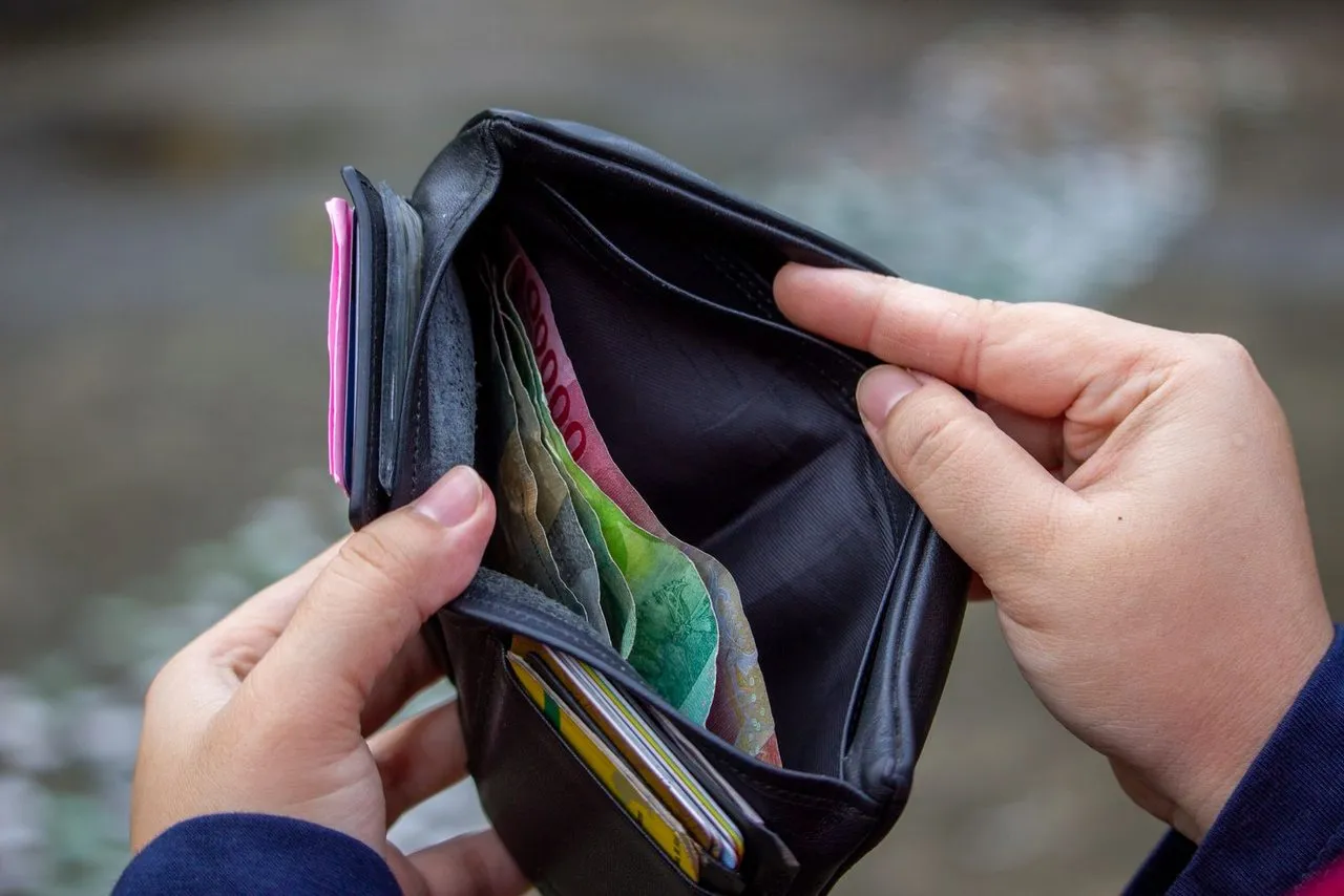 Dompet berisi uang rupiah di tangan