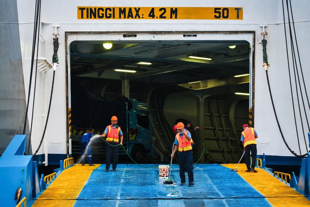 Petugas membersihkan rampa kapal feri di pelabuhan