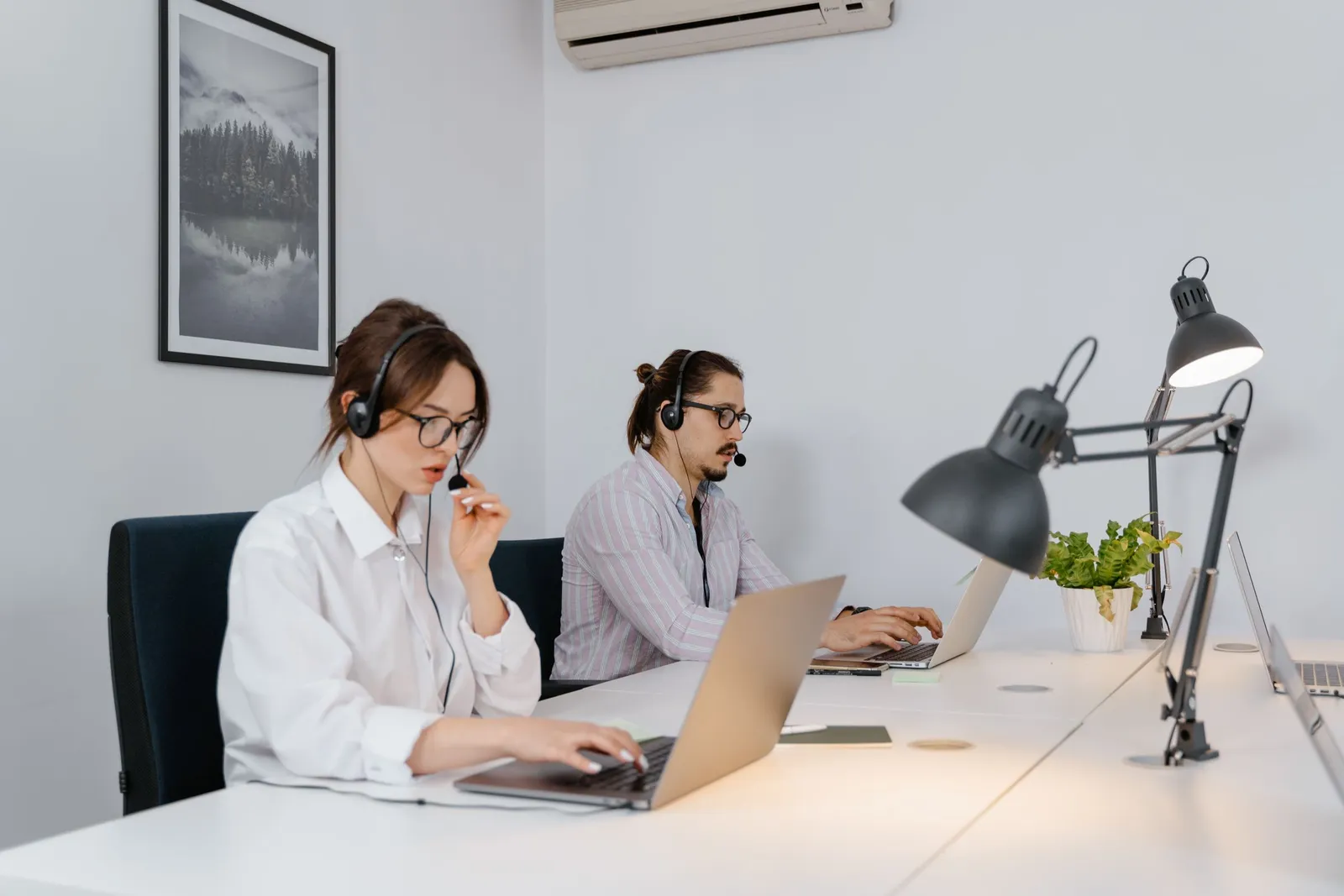 Dua agen layanan pelanggan bekerja dengan headset